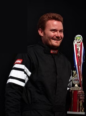 Austin Webb in his race suit, holding a trophy